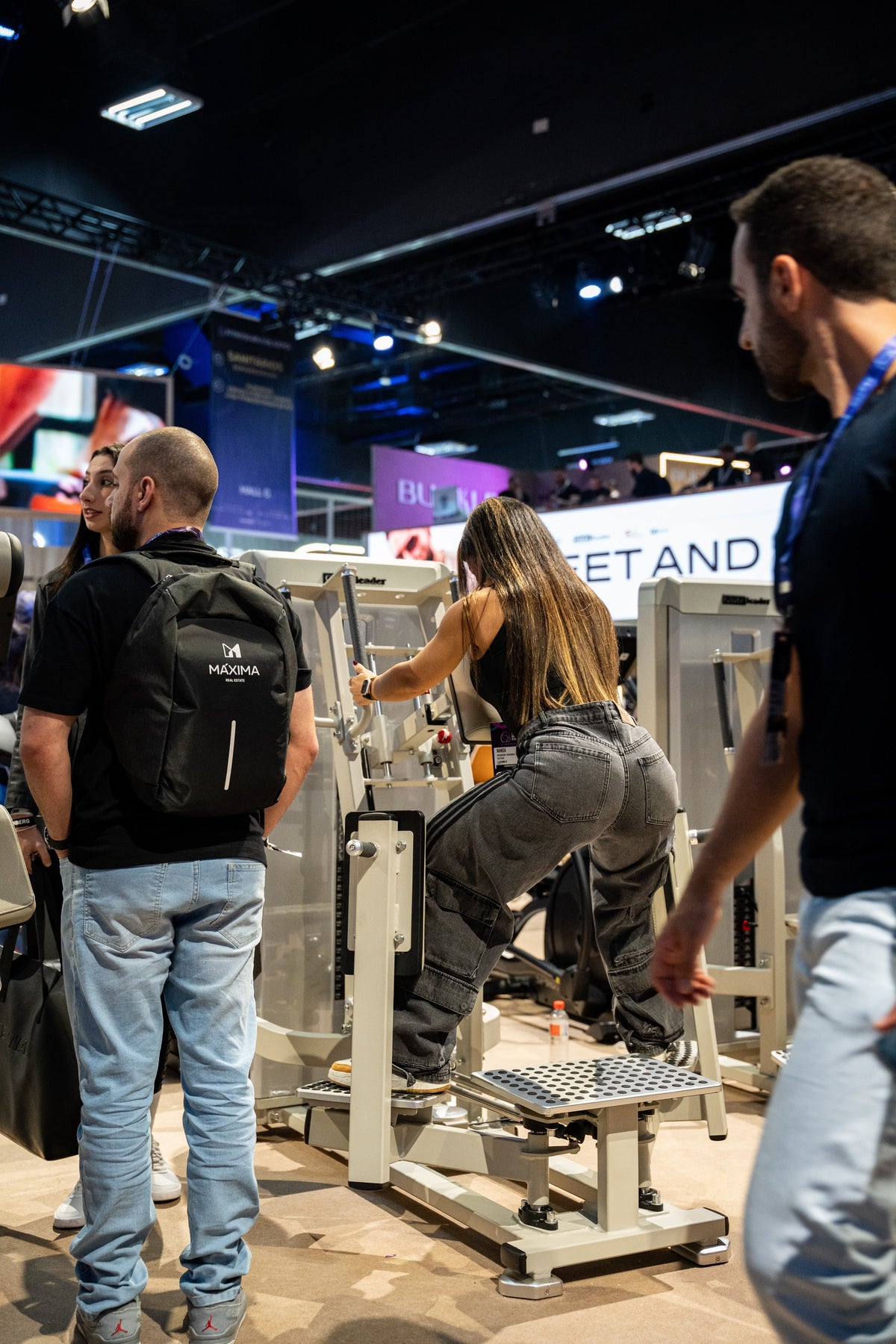 Athlete using the GluteLeader Standing Hip Abductor GL-1005 at a fitness exhibition