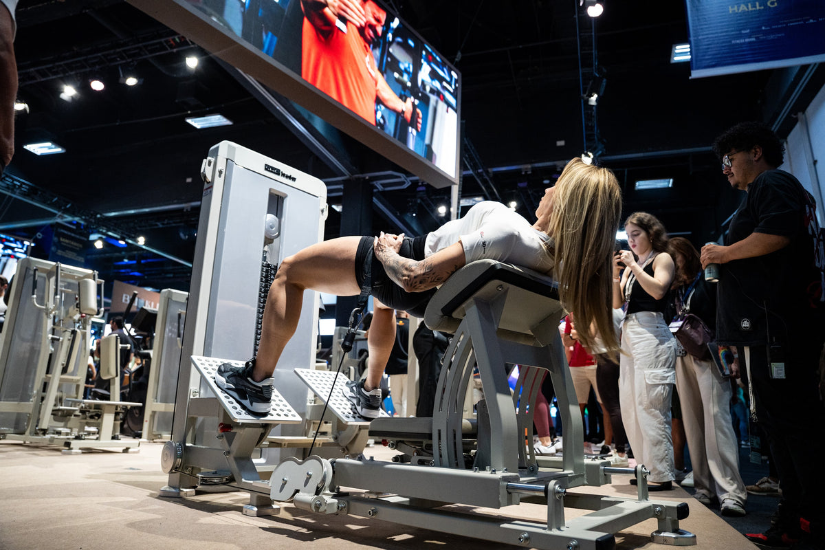 Athlete using the GluteLeader Selectorised Hip Thrust at a fitness exhibition