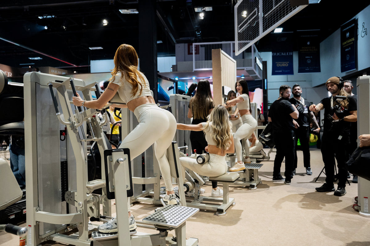 Gluteleader standing machines in use on the fitness expo stand