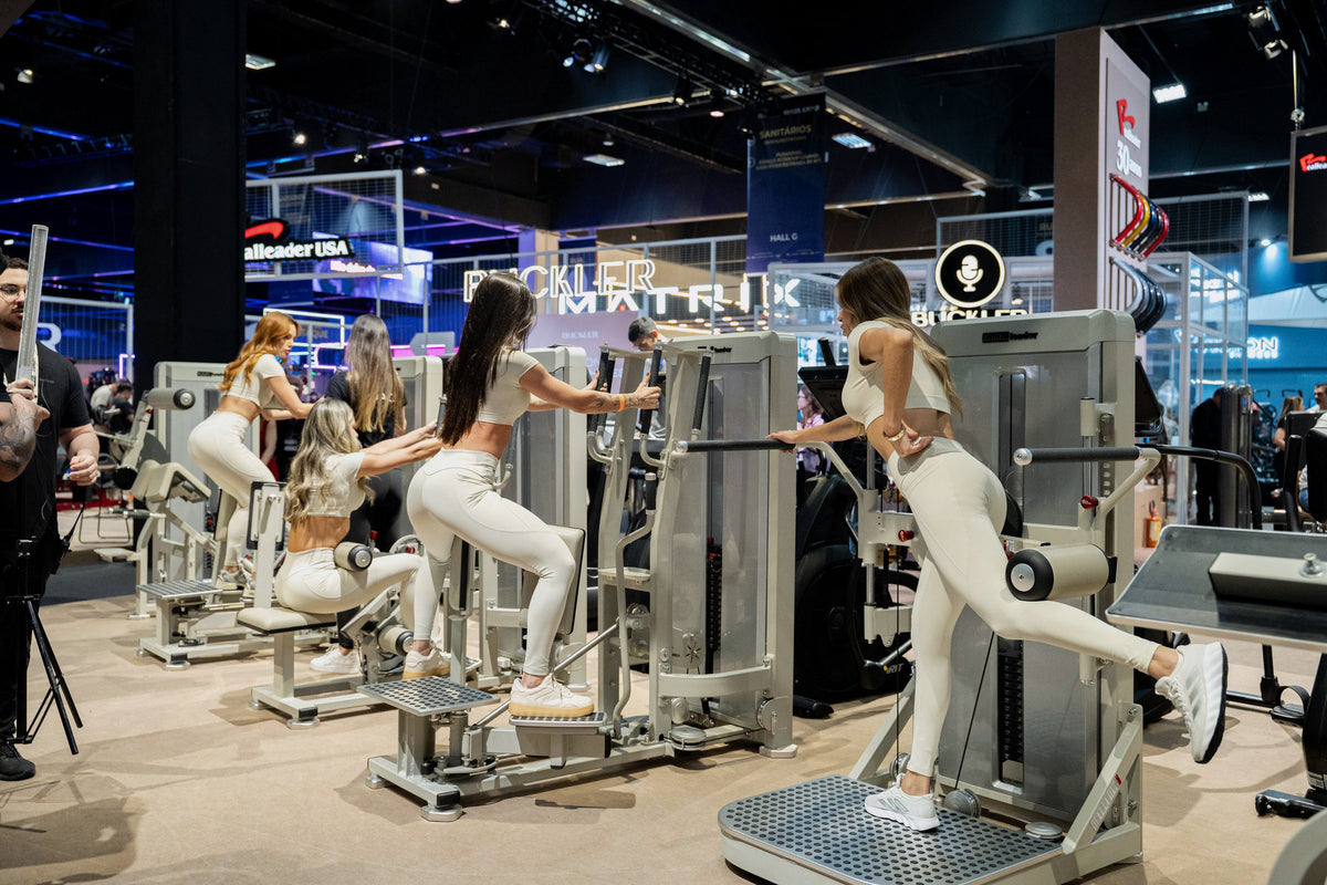Athletes demonstrating the Gluteleader equipment range at the fitness expo